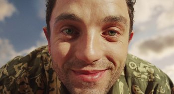 Movie still from “Attila Marcel” (2013), directed by Sylvain Chomet – A man smiling for the camera; Extreme Close Up shot, Overhead angle