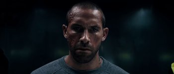 Movie still from “Avengement” (2019), directed by Jesse V. Johnson – A person wearing a shirt; Close Up shot, Low angle