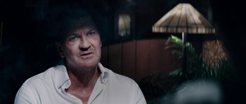 Movie still from “Avengement” (2019), directed by Jesse V. Johnson – An older man is looking at the camera; Close Up shot, Over the shoulder angle