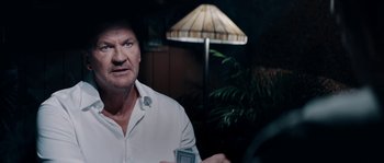 Movie still from “Avengement” (2019), directed by Jesse V. Johnson – A person holding a camera in a room; Close Up shot, Over the shoulder angle