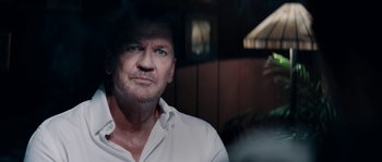 Movie still from “Avengement” (2019), directed by Jesse V. Johnson – A person wearing a white shirt; Close Up shot, Over the shoulder angle