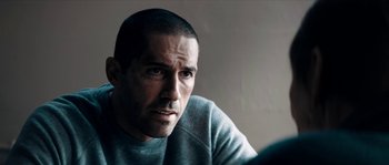 Movie still from “Avengement” (2019), directed by Jesse V. Johnson – A person wearing a sweatshirt; Close Up shot, Over the shoulder angle
