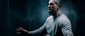 Movie still from “Avengement” (2019), directed by Jesse V. Johnson – A man with a tattoo on his arm is yelling; Medium shot, Low angle