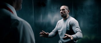 Movie still from “Avengement” (2019), directed by Jesse V. Johnson – A man standing in front of a bathroom mirror; Medium shot, Low angle