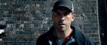 Movie still from “Avengement” (2019), directed by Jesse V. Johnson – A person wearing a hat; Close Up shot, Over the shoulder angle