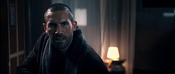 Movie still from “Avengement” (2019), directed by Jesse V. Johnson – A person wearing a robe; Close Up shot, Over the shoulder angle