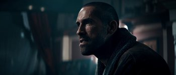 Movie still from “Avengement” (2019), directed by Jesse V. Johnson – A person wearing a robe; Close Up shot, Low angle
