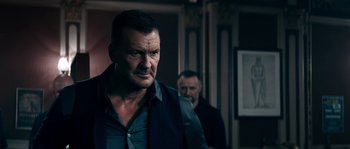 Movie still from “Avengement” (2019), directed by Jesse V. Johnson – A man in a black shirt and a man in a black jacket; Medium shot, Over the shoulder angle
