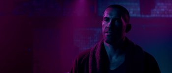 Movie still from “Avengement” (2019), directed by Jesse V. Johnson – A person with a towel on his head; Close Up shot, Over the shoulder angle