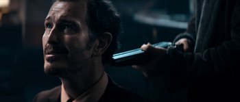 Movie still from “Avengement” (2019), directed by Jesse V. Johnson – A man getting his hair cut by a barber; Close Up shot, Over the shoulder angle