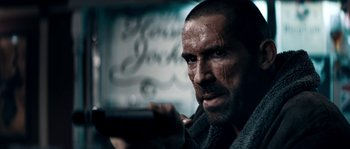 Movie still from “Avengement” (2019), directed by Jesse V. Johnson – A person holding a cell phone; Close Up shot, Low angle