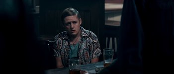 Movie still from “Avengement” (2019), directed by Jesse V. Johnson – A man sitting at a table with two glasses of beer; Medium shot, Over the shoulder angle