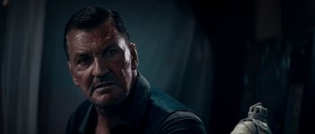 Movie still from “Avengement” (2019), directed by Jesse V. Johnson – An older man is looking at the camera; Close Up shot, Low angle