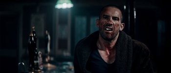 Movie still from “Avengement” (2019), directed by Jesse V. Johnson – A person with blood on his face; Close Up shot, Over the shoulder angle