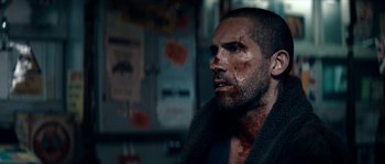 Movie still from “Avengement” (2019), directed by Jesse V. Johnson – A person with blood all over his face; Close Up shot, Over the shoulder angle