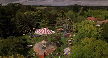 Movie still from “Babe” (1995), directed by Chris Noonan – An aerial view of an amusement park with a lot of people; Extreme Wide shot, High angle