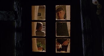 Movie still from “Babe” (1995), directed by Chris Noonan – Two people looking out of a window at each other; Medium shot, Low angle