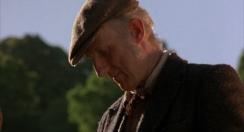 Movie still from “Babe” (1995), directed by Chris Noonan – An older man wearing a hat and a jacket; Close Up shot, Low angle