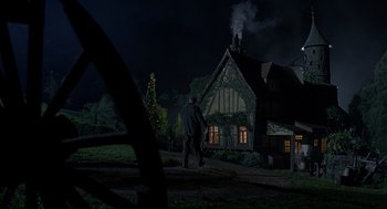 Movie still from “Babe” (1995), directed by Chris Noonan – A man walking down a path in front of a house at night; Extreme Wide shot, Low angle
