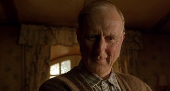 Movie still from “Babe” (1995), directed by Chris Noonan – An old man with a beard and a sweater; Close Up shot, Low angle