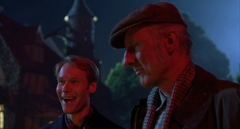 Movie still from “Babe” (1995), directed by Chris Noonan – A man and a man with a hat on; Close Up shot, Over the shoulder angle