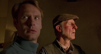 Movie still from “Babe” (1995), directed by Chris Noonan – A man and a man with a hat and a sweater; Close Up shot, Low angle