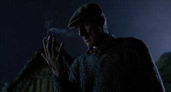 Movie still from “Babe” (1995), directed by Chris Noonan – A man wearing a hat clapping his hands in the dark; Close Up shot, Low angle