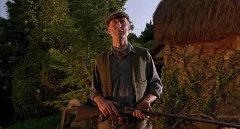 Movie still from “Babe” (1995), directed by Chris Noonan – An older man holding a rifle in his hands; Medium shot, Low angle