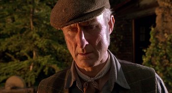 Movie still from “Babe” (1995), directed by Chris Noonan – An older man wearing a hat and a tie; Close Up shot, Low angle