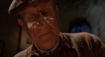 Movie still from “Babe” (1995), directed by Chris Noonan – An older man wearing glasses and a hat; Close Up shot, Low angle
