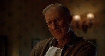 Movie still from “Babe” (1995), directed by Chris Noonan – An older man wearing a brown sweater and a white shirt; Close Up shot, Over the shoulder angle