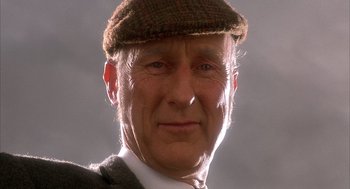 Movie still from “Babe” (1995), directed by Chris Noonan – An older man wearing a hat and a suit; Close Up shot, Low angle