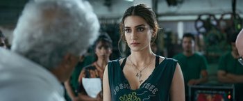 A beautiful young woman wearing a necklace and looking at the camera