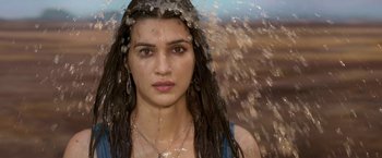 A young woman with long hair is covered in water