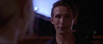 Movie still from “Backdraft” (1991), directed by Ron Howard – A person wearing a black shirt; Close Up shot, Low angle