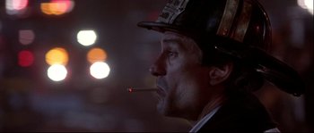 Movie still from “Backdraft” (1991), directed by Ron Howard – A person smoking a cigarette; Close Up shot, Low angle