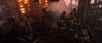 Movie still from “Backdraft” (1991), directed by Ron Howard – A group of firemen are fighting a fire in a building; Wide shot, High angle