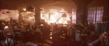 Movie still from “Backdraft” (1991), directed by Ron Howard – A group of firemen are in a building with a large fire; Wide shot, High angle