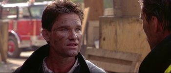 Movie still from “Backdraft” (1991), directed by Ron Howard – A person wearing a jacket; Close Up shot, Low angle