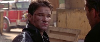 Movie still from “Backdraft” (1991), directed by Ron Howard – A person wearing a leather jacket; Close Up shot, Low angle