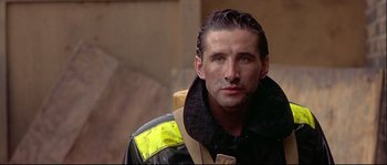 Movie still from “Backdraft” (1991), directed by Ron Howard – A person wearing a jacket; Close Up shot, Low angle