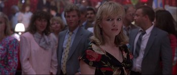 Movie still from “Backdraft” (1991), directed by Ron Howard – A woman standing in front of a group of people; Close Up shot, Over the shoulder angle