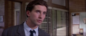 Movie still from “Backdraft” (1991), directed by Ron Howard – A person wearing a suit and tie; Close Up shot, Low angle