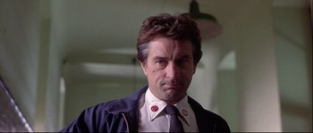 Movie still from “Backdraft” (1991), directed by Ron Howard – A person wearing a suit and tie; Close Up shot, Low angle