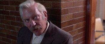 Movie still from “Backdraft” (1991), directed by Ron Howard – An old man with a mustache and a beard; Close Up shot, Low angle