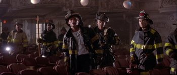 Movie still from “Backdraft” (1991), directed by Ron Howard – A couple of firemen standing next to each other; Medium shot, Low angle