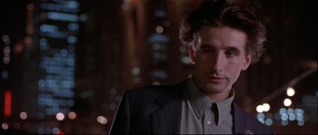 Movie still from “Backdraft” (1991), directed by Ron Howard – A person wearing a suit and tie; Close Up shot, Low angle