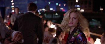 Movie still from “Backdraft” (1991), directed by Ron Howard – A woman with blonde hair standing next to a crowd of onlookers; Medium shot, Over the shoulder angle