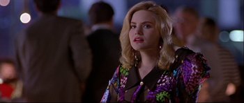 Movie still from “Backdraft” (1991), directed by Ron Howard – A woman with blonde hair wearing a colorful jacket; Close Up shot, Over the shoulder angle