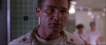 Movie still from “Backdraft” (1991), directed by Ron Howard – A person wearing a white shirt; Close Up shot, Low angle